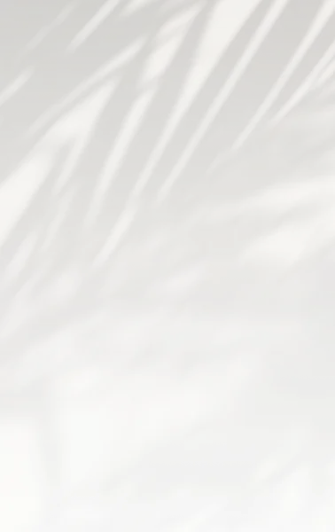 White fabric with soft diagonal folds and wrinkles creating texture and shadows on light background