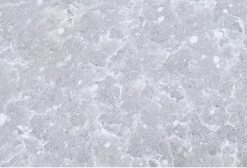 Fresh white snow texture with scattered snowflakes and crystalline patterns on winter surface