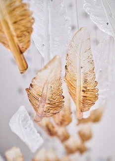Gold-dipped feather decorations hanging as elegant bohemian wedding or party decor