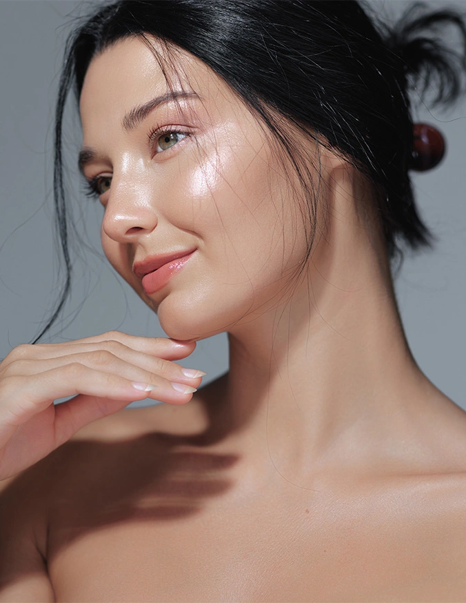 Natural beauty woman with glowing dewy skin and minimal makeup touching face in skincare portrait - PDO thread lift In Cleveland, OH