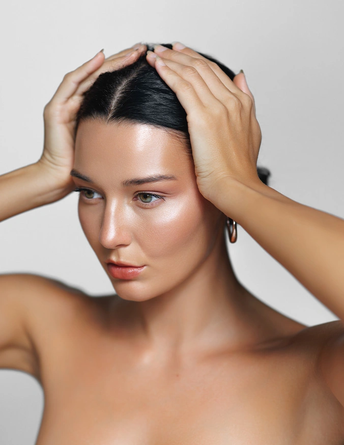 Woman with hands on head showing clear skin and natural beauty for skincare or wellness concept - Scarlet RF microneedling In Cleveland, OH